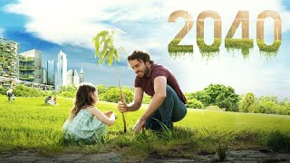 Image of an adult sitting outside with a child. The adult is holding a branch. Both are sitting in grass, and in the background is more grass and trees. The number 2040 hangs in the sky in brown numbers, and the bottom of the numbers are green roots.